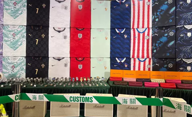 Hong Kong customs authorities showcase various types of fake goods they seized during a news conference at its headquarters in North Point, Hong Kong Thursday, June 11, 2026. (AP Photo/Kanis Leung)