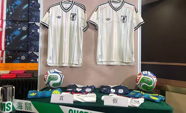 Hong Kong customs authorities showcase real jersey, left, and fake jersey, right, during a news conference at its headquarters in North Point, Hong Kong Thursday, June 11, 2026. (AP Photo/Kanis Leung)