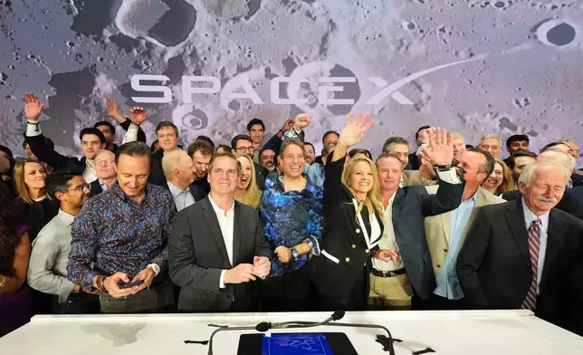 Gwynne Shotwell, President and COO of SpaceX, third from right, celebrates with colleagues during a bell ringing ceremony for the IPO of SpaceX at the Nasdaq MarketSite in New York, Friday, June 12, 2026, in New York. (AP Photo/Frank Franklin II)