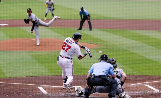 Atlanta Braves' Austin Riley (27) strikes out with the based loaded against Pittsburgh Pirates pitcher Mason Montgomery, left, during the first inning of a baseball game, Sunday, June 7, 2026, in Atlanta. (AP Photo/Erik S. Lesser)