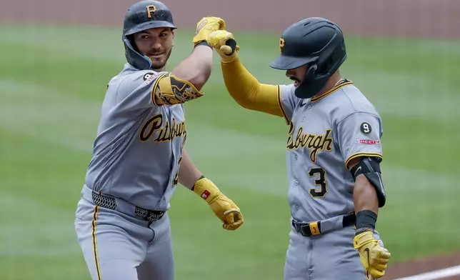 Pittsburgh Pirates' Spencer Horwitz, left, is greeted by Nick Gonzales, right, after hitting a leadoff home run against the Atlanta Braves during the first inning of a baseball game, Sunday, June 7, 2026, in Atlanta. (AP Photo/Erik S. Lesser)