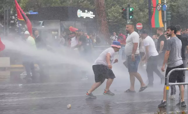 Police use a water cannon to disperse protesters during a demonstration in Tirana, Albania, Wednesday, June 3, 2026, opposing a luxury coastal development project linked to Jared Kushner and Ivanka Trump over concerns about environmental impacts and transparency. (AP Photo/Hameraldi Agolli)