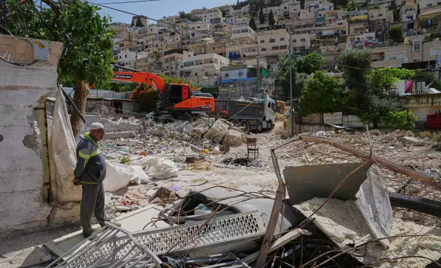 A Palestinian man looks on as an excavator clears the rubble of homes demolished by Israeli authorities in the Silwan neighborhood of east Jerusalem, May 19, 2026. (AP Photo/Mahmoud Illean)