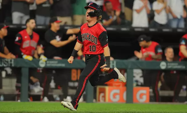 Chicago White Sox's Chase Meidroth scores on Tristan Peters two run RBI triple during the fifth inning of a baseball game against the Los Angeles Dodgers, Friday, June 12, 2026, in Chicago. (AP Photo/Melissa Tamez)