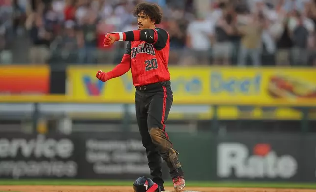 Chicago White Sox's Miguel Vargas (20) celebrates after hitting a RBI double during the fifth inning of a baseball game against the Los Angeles Dodgers, Friday, June 12, 2026, in Chicago. (AP Photo/Melissa Tamez)