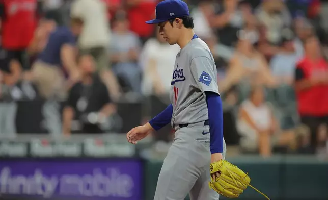 Los Angeles Dodgers' Roki Sasaki exits the game during the fifth inning of a baseball game against the Chicago White Sox, Friday, June 12, 2026, in Chicago. (AP Photo/Melissa Tamez)