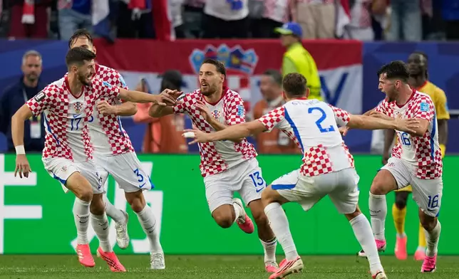 Croatia's Nikola Vlasic (13) celebrates with teammates after scoring his side's second goal during the World Cup Group L soccer match between Croatia and Ghana in Philadelphia, Saturday, June 27, 2026. (AP Photo/Matt Slocum)