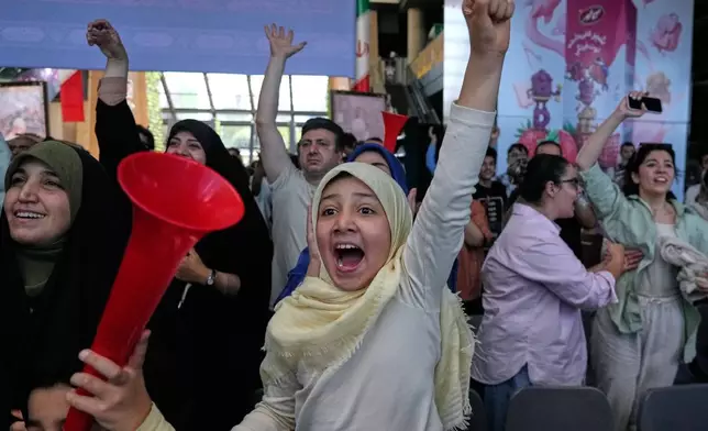 Iranian fans celebrate after Iran appeared to score against Egypt, before the goal was later disallowed by VAR, while watching a live broadcast of the teams' World Cup Group G match at the Book Garden bookstore converted into a World Cup viewing venue in Tehran, Iran, Saturday, June 27, 2026. (AP Photo/Vahid Salemi)