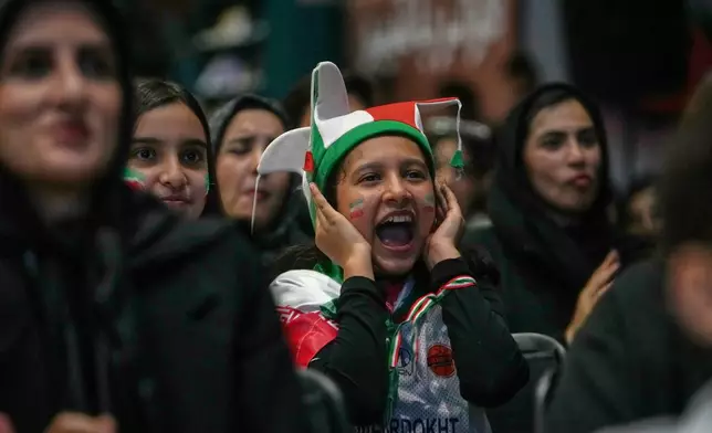An Iranian fan reacts while watching a live broadcast of Iran's World Cup Group G match against Belgium at a bookstore converted into a World Cup viewing venue in Tehran, Iran, Sunday, June 21, 2026. (AP Photo/Vahid Salemi)