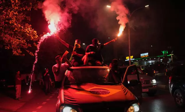 Supporters of Brazil's national soccer team celebrate after Brazil defeated Japan in a Round of 32 soccer match at the FIFA World Cup, in Zgharta, northern Lebanon, Monday, June 29, 2026. (AP Photo/Hassan Ammar)