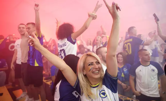 Bosnian national team soccer fans react as they watch a broadcast of the FIFA World Cup Group B soccer match between Bosnia and Qatar, at a fan zone in in Sarajevo, Bosnia, Wednesday, June 24, 2026. (AP Photo/Armin Durgut)
