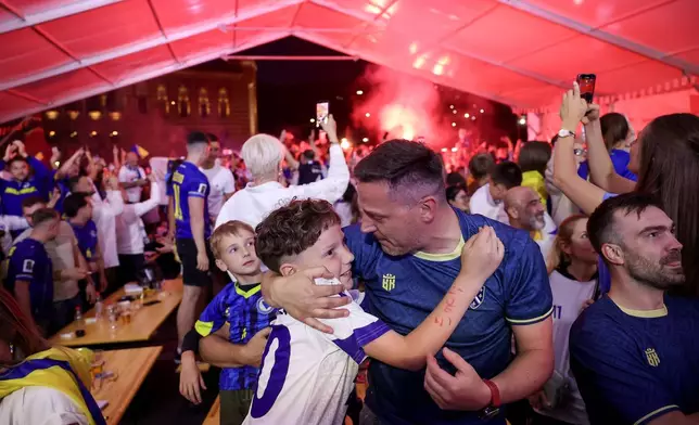 Bosnian fans celebrate at a fan festival, Friday, June 12, 2026, in Sarajevo, Bosnia, after Bosnia scored the opening goal as they watch a broadcast of the World Cup Group B soccer match between Canada and Bosnia. (AP Photo/Armin Durgut)