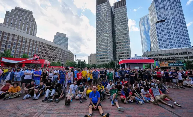 People watching the World Cup Group L soccer match between England and Croatia at a public viewing in central Boston, Mass, Wednesday, June 17, 2026. (AP Photo/Martin Meissner)