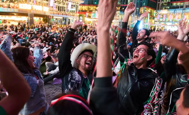 Fans react as they watch a broadcast of the World Cup soccer match between Mexico and South Africa in Berlin, Germany, Thursday, June 11, 2026. (AP Photo/Ebrahim Noroozi)
