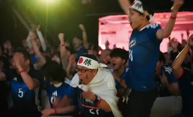 People react to Japan's second goal as they watch their World Cup Group F soccer match against Tunisia in Mexico, during a public viewing event in Tokyo, Sunday, June 21, 2026. (AP Photo/Hiro Komae)