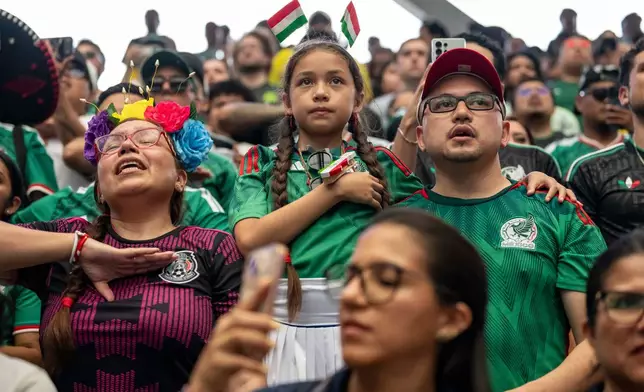 Supporters of Mexico sing the national anthem before the opening match of the World Cup soccer tournament between Mexico and South Africa, Thursday, June 11, 2026, at the USTA Billie Jean King National Tennis Center in New York. (AP Photo/Yuki Iwamura)