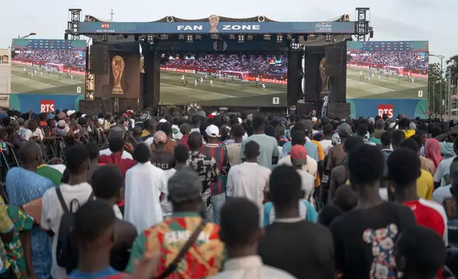 Senegal fans follow a World Cup soccer match between Senegal and Iraq at the Place de la Nation fan zone in Dakar, Senegal, Friday, June 26, 2026. (AP Photo/Sylvain Cherkaoui)