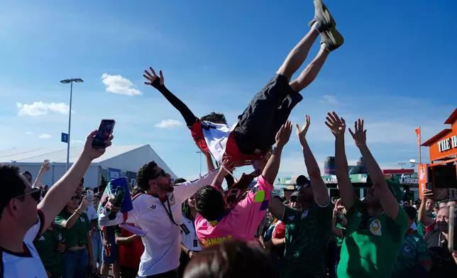 A fan is tossed into the air ahead of the World Cup Group A soccer match between Mexico and South Korea in Zapopan, near Guadalajara, Mexico, Thursday, June 18, 2026. (AP Photo/Eduardo Verdugo)