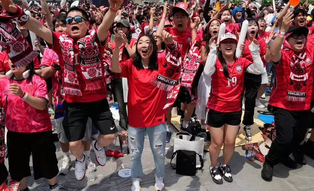 South Korean soccer fans react as they watch a live broadcasting of the Group A World Cup soccer match between South Korea and Czechia in Mexico, at a public viewing venue in Seoul, South Korea, Friday, June 12, 2026. (AP Photo/Ahn Young-joon)