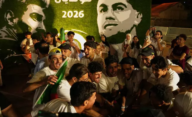 Soccer fans celebrate during the opening of the Damascus World Cup Festival, a public fan zone featuring giant screens for World Cup match broadcasts, at the Damascus Fairgrounds in Damascus, Syria, Thursday, June 11, 2026. (AP Photo/Omar Albam)
