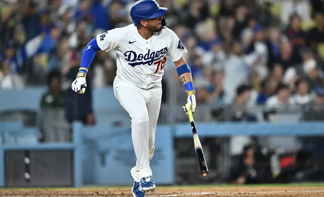 Los Angeles Dodgers' Miguel Rojas watches his home run during the seventh inning of a baseball game against the Tampa Bay Rays, Monday, June 15, 2026, in Los Angeles. (AP Photo/William Liang)