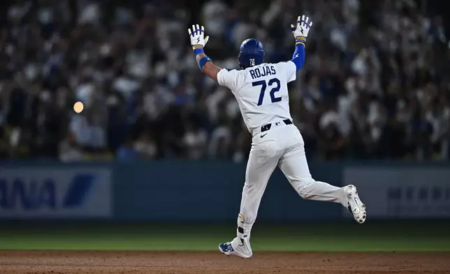 Los Angeles Dodgers' Miguel Rojas gestures after hitting a home run during the seventh inning of a baseball game against the Tampa Bay Rays, Monday, June 15, 2026, in Los Angeles. (AP Photo/William Liang)