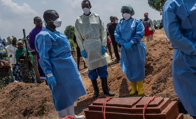 Red Cross workers prepare to bury Vanisa Anifa, a 6-month-old orphaned girl who died of Ebola, at the Bigo Cemetery, in Bunia, Congo, Friday, June 19, 2026. (AP Photo/Moses Sawasawa)