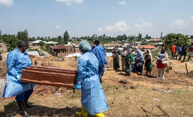 Red Cross workers prepare to bury Vanisa Anifa, a 6-month-old orphaned girl who died of Ebola, at the Bigo Cemetery, in Bunia, Congo, Friday, June 19, 2026. (AP Photo/Moses Sawasawa)