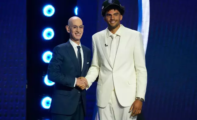 Cameron Boozer, right, poses for a photo with Adam Silver, left, NBA Commissioner, after being selected by the Memphis Grizzlies in the first round of the NBA basketball draft, Tuesday, June 23, 2026, in New York. (AP Photo/Yuki Iwamura)