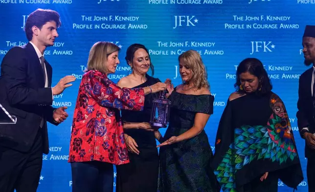 Former ambassador Caroline Kennedy, second from left, and her son Jack Schlossberg, left, present Natalie Ehret, Zena Stenvik, Carolina Ortiz and Imam Yusuf Abdulle (from left) the Profile in Courage Award during a ceremony at the John F. Kennedy Presidential Library, Sunday, May 31, 2026, in Boston. (AP Photo/Charles Krupa)