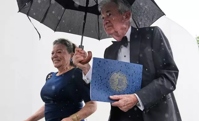 Federal Reserve Board Governor Jerome Powell, the former Federal Reserve chair, right, arrives with his wife Elissa Leonard for the Profile in Courage Award at the John F. Kennedy Presidential Library, Sunday, May 31, 2026, in Boston. (AP Photo/Charles Krupa)