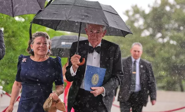 Federal Reserve Board Governor Jerome Powell, the former Federal Reserve chair, center, arrives with his wife Elissa Leonard, left, for the Profile in Courage Award at the John F. Kennedy Presidential Library, Sunday, May 31, 2026, in Boston. (AP Photo/Charles Krupa)