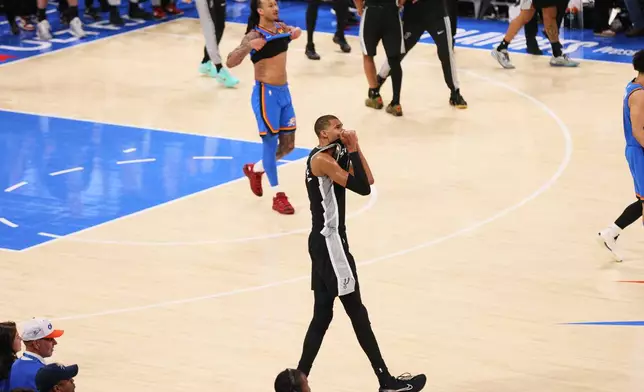 San Antonio Spurs forward Victor Wembanyama (1) celebrates while Oklahoma City Thunder forward Jaylin Williams walks off court as time expires in the second half of Game 7 of the Western Conference finals of the NBA basketball playoffs series Saturday, May 30, 2026, in Oklahoma City. (AP Photo/Nate Billings)