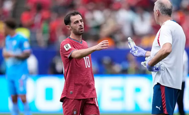 Portugal's Bernardo Silva takes a bottle of water during a hydration break during the World Cup Group K soccer match between Portugal and Congo in Houston, Wednesday, June 17, 2026. (AP Photo/Ashley Landis)