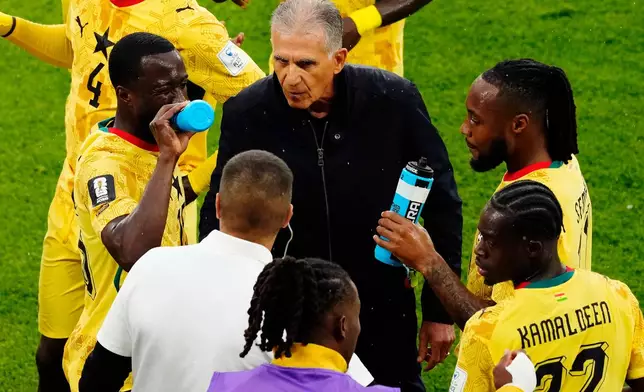 Ghana manager Carlos Queiroz speaks with his players during a hydration break during the World Cup Group L soccer match between Ghana and Panama in Toronto, Wednesday, June 17, 2026. (Chris Young/The Canadian Press via AP)