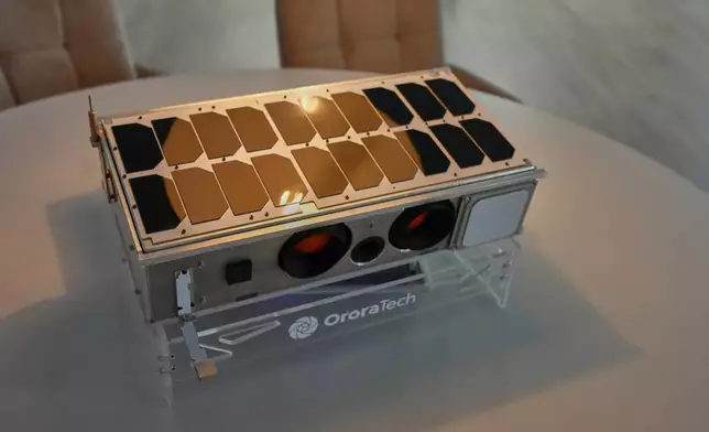 A replica of an OroraTech wildfire-detection satellite is displayed at the company's facilities in Athens, Greece, on Thursday, June 18, 2026, as Greece integrates a new constellation of wildfire-detection satellites into its national firefighting system. (AP Photo/Petros Giannakouris)
