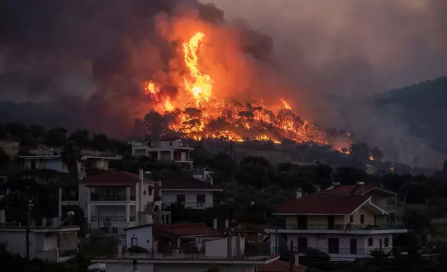 FILE - Fire burns near the village of Galataki as authorities evacuate the place near Corinth, Greece, July 22, 2020.(AP Photo/Petros Giannakouris, File)