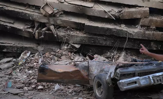 EDS NOTE: GRAPHIC CONTENT - Bodies remain trapped under the rubble of a collapsed building three days after an earthquake struck La Guaira, Venezuela, Saturday, June 27, 2026. (AP Photo/Matias Delacroix)