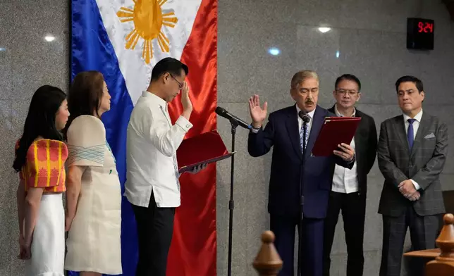 New Senate President Sherwin Gatchalian, third from left, takes his oath during a special session at the Philippine Senate in Pasay city, Philippines on Wednesday, June 17, 2026. (AP Photo/Aaron Favila)