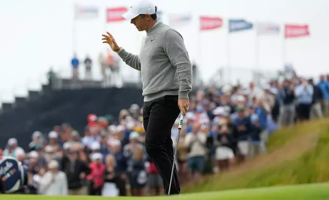 Rory McIlroy, of Northern Ireland, waves after his putt on the 11th hole during the first round of the U.S. Open golf tournament at Shinnecock Hills Golf Club in Southampton, N.Y., Thursday, June 18, 2026.(AP Photo/George Walker IV)