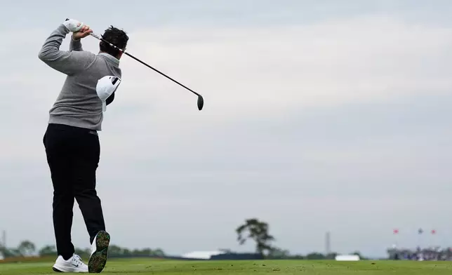 Rory McIlroy, of Northern Ireland, looses his hat in the wind on the 13th hole during the first round of the U.S. Open golf tournament at Shinnecock Hills Golf Club in Southampton, N.Y., Thursday, June 18, 2026.(AP Photo/George Walker IV)