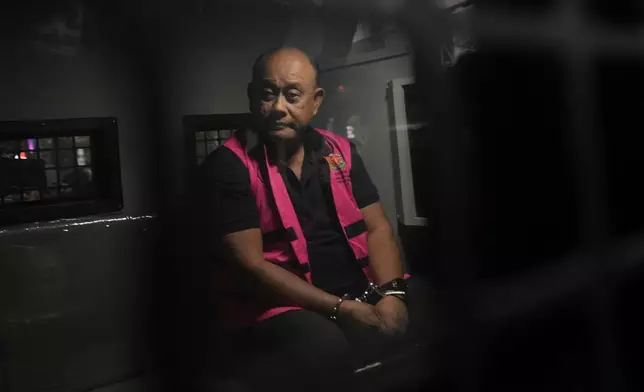 Former head of Indonesia's National Nutrition Agency Dadan Hindayana sits inside a detention car after being named as a corruption suspect, at the Attorney Genera's Office in Jakarta, Indonesia, Wednesday, June 3, 2026. (AP Photo/Achmad Ibrahim)