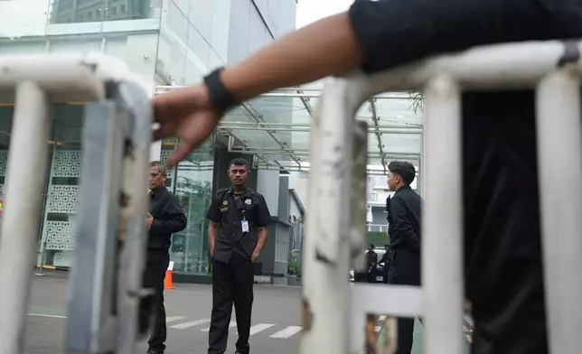 Security personnel guard the entrance of the office of the National Nutrition Agency as it is being searched by prosecutors, in Jakarta, Indonesia, Wednesday, June 3, 2026. (AP Photo/Dita Alangkara)