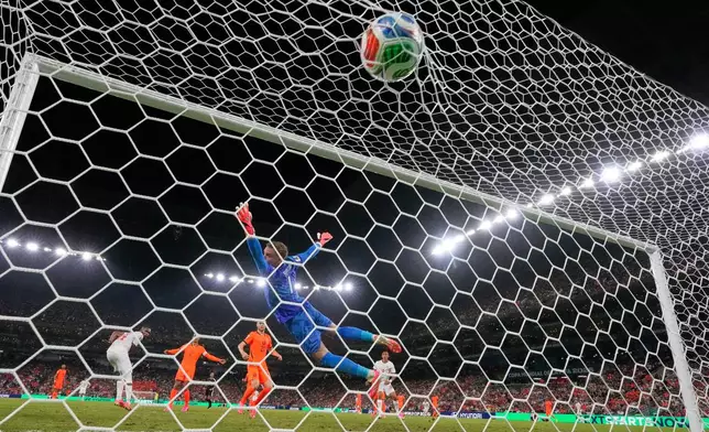 Morocco's Issa Diop (14), left, scores their opening goal during the World Cup round of 32 soccer match between the Netherlands and Morocco in Guadalupe, near Monterrey, Mexico, Monday, June 29, 2026. (AP Photo/Ricardo Mazalan )