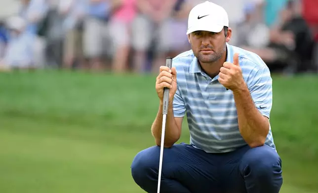 Scottie Scheffler gives a thumbs up to his caddie on the 9th hole during the second round of the Travelers Championship golf tournament at TPC River Highlands, Friday, June 26, 2026, in Cromwell, Conn. (AP Photo/Jessica Hill)