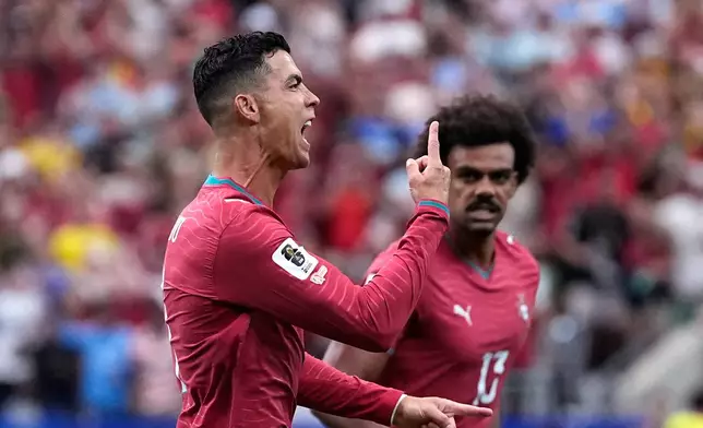 Portugal's Cristiano Ronaldo celebrates after scoring the opening goal during the World Cup Group K soccer match between Portugal and Uzbekistan in Houston, Tuesday, June 23, 2026. (AP Photo/Ashley Landis)