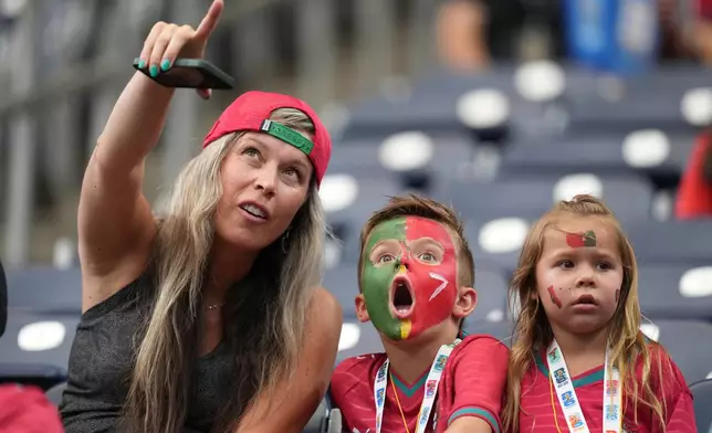 A child reacts before the World Cup Group K soccer match between Portugal and Uzbekistan in Houston, Tuesday, June 23, 2026. (AP Photo/Eric Gay)