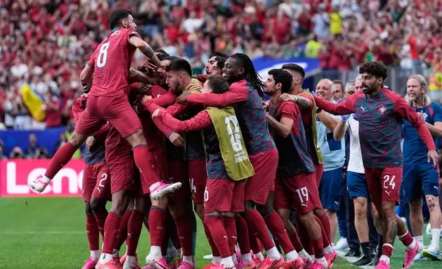 Portugal players celebrate after Cristiano Ronaldo scored the opening goal during the World Cup Group K soccer match between Portugal and Uzbekistan in Houston, Tuesday, June 23, 2026. (AP Photo/Ashley Landis)