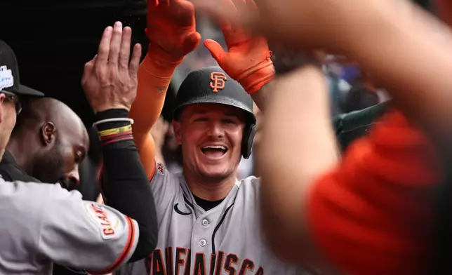 The San Francisco Giants' Matt Chapman celebrates in the dugout after hitting a grand slam during the fourth inning of a baseball game against the Chicago Cubs, Friday, June 5, 2026, in Chicago. (AP Photo/Geoff Stellfox)