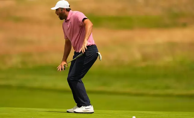 Scottie Scheffler reacts after missing a putt on the 13th hole during the first round of the U.S. Open golf tournament at Shinnecock Hills Golf Club in Southampton, N.Y., Thursday, June 18, 2026.(AP Photo/Gerald Herbert)
